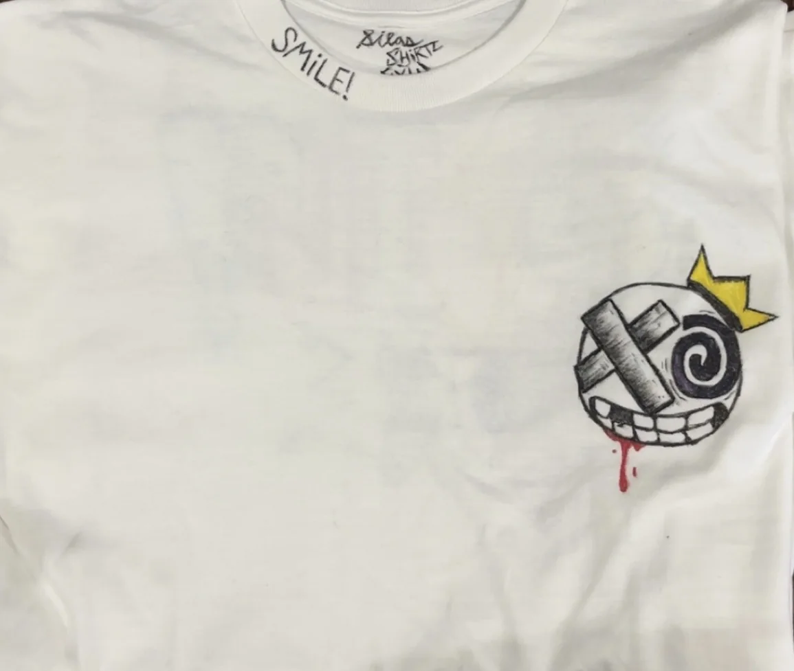 Hand-drawn Smile artwork on a white shirt