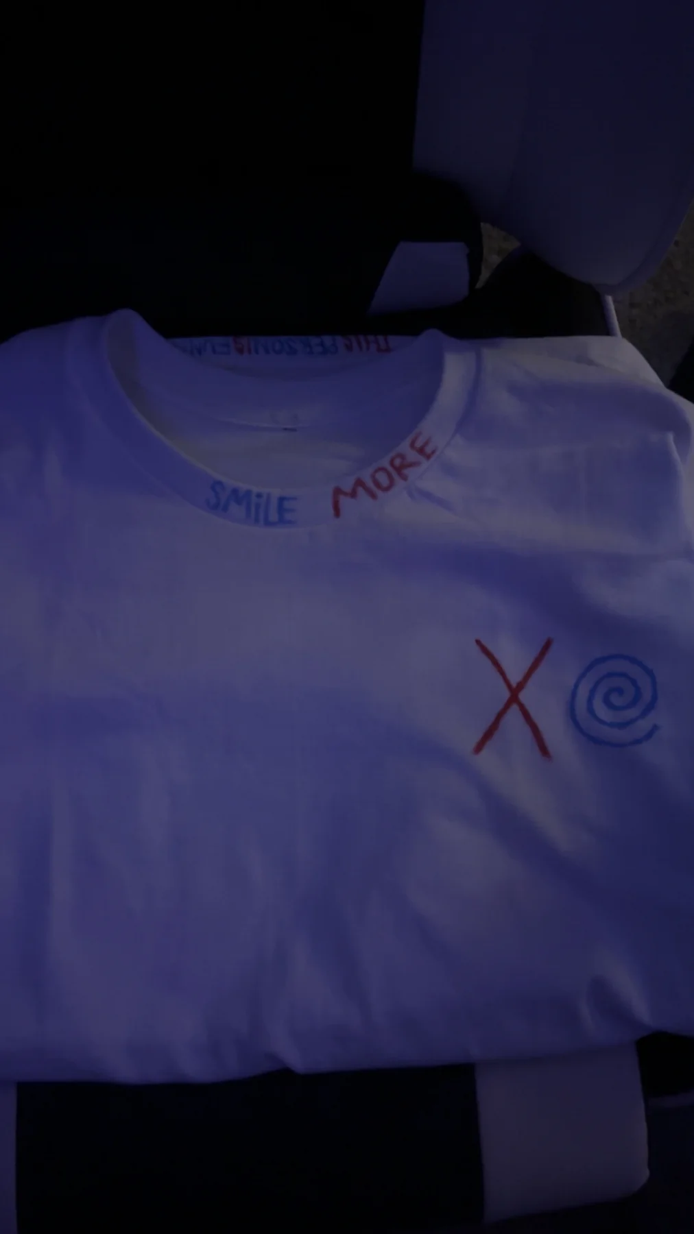 White handmade shirt with large red and blue Smile More lettering